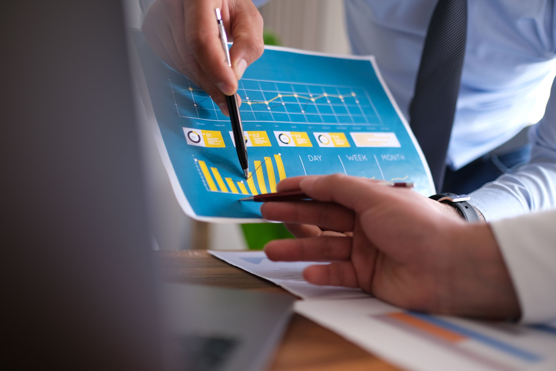Negotiation, analysis, discussion,asian male economist using tablet explaining the investment finance program to the company owner to plan marketing and hedging business risks